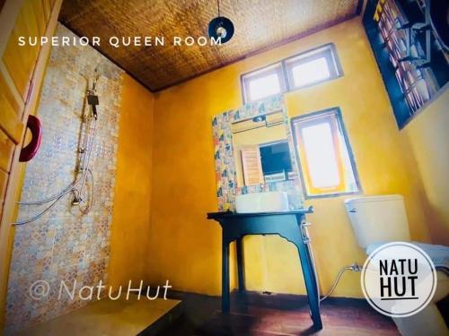 a bathroom with a sink and a mirror at Natu Hut Farm Stay & Cafe' Chiang Mai in Mae Taeng