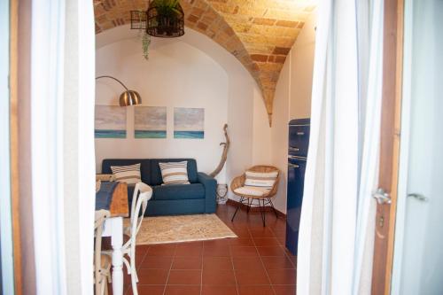 a living room with a blue couch and a table at loft sul mare Sirolo in Sirolo