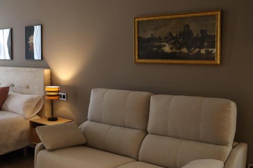a living room with a couch and a painting on the wall at La Quinta del Sordo in Luarca