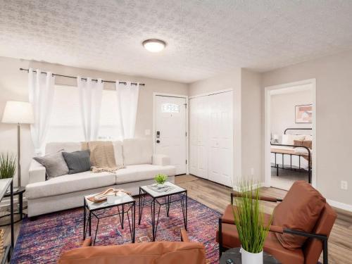 a living room with a couch and a table at Urban Oasis w Hot Tub Near Downtown & Arena District in Columbus