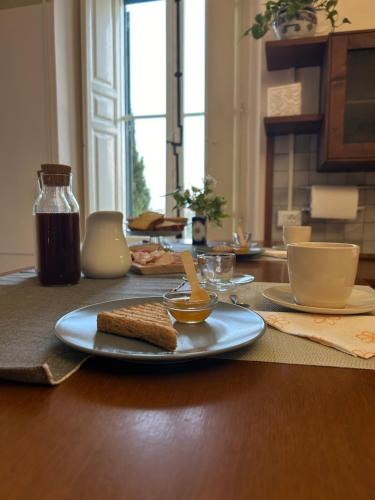 a table with a plate of food on a table at Palazzo Antico in Loreto Aprutino