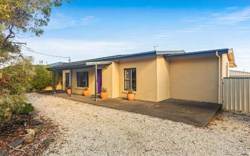 a house with a driveway in front of it at The Purple Door on Seaview in Victor Harbor