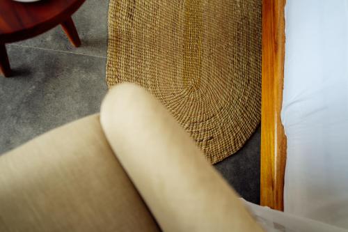 a close up of the arm of a couch at Savera Beach Houses in Jambiani