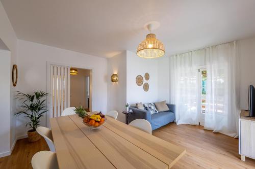 a living room with a table and a blue couch at Casa da Vigia - Santa Cruz - Casa com Jardim a 4 Min da Praia in A dos Cunhados