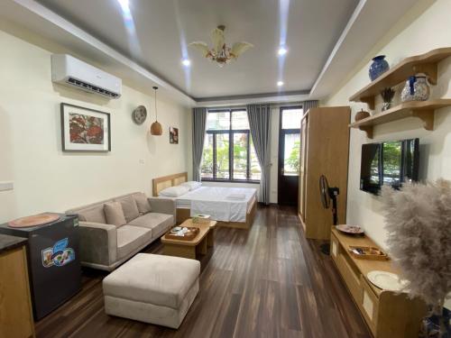 a living room with a couch and a table at An Thuong House - Hoan Kiem, Hanoi Center in Hanoi