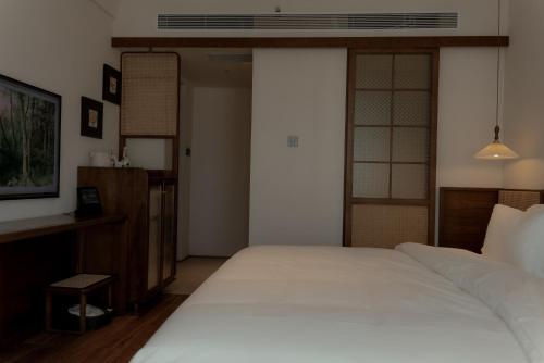 Postel nebo postele na pokoji v ubytování 昆明市呈贡区椿屿岚酒店 Chun Yulan Hotel