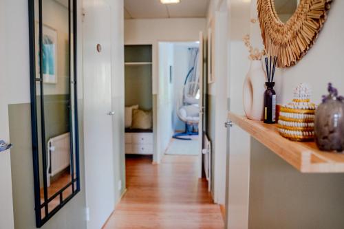 a hallway of a home with a mirror on the wall at West Coast Hideaway in Pietarsaari
