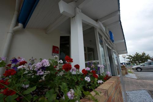 a flower garden in front of a store at ibis budget Saint Paul Les Dax in Saint-Paul-lès-Dax