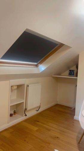 an empty room with a ceiling with a radiator at Lily in Whetstone