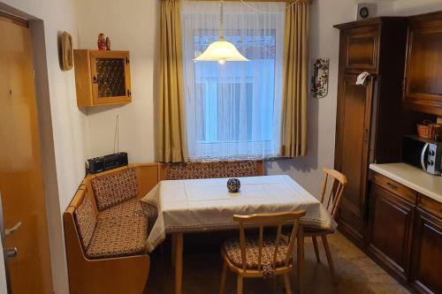 a kitchen with a table and chairs and a window at Gemütliches Haus im alten Ortskern in Wehrheim
