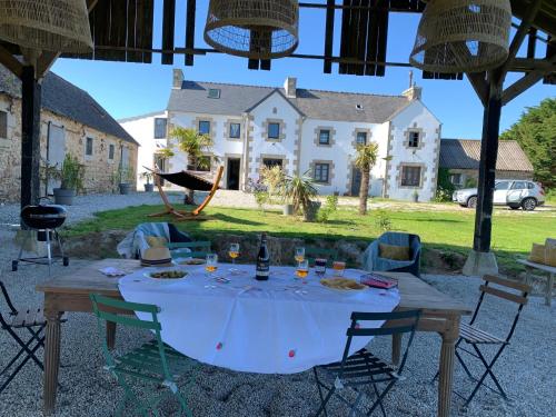 a table with a white table cloth on it with a house at Ty Koant in Cléder
