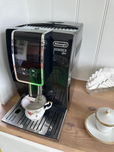 a coffee maker sitting on a counter with a cup at Stara Szkola - Wielki Medromierz 59 in Wielki Modromierz