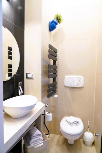 a bathroom with a sink and a toilet at Dimora Le Vele - ELEGANZA con VISTA MARE in Ostuni