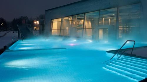 a swimming pool with blue lights in front of a building at Central-Vintage Villa with free Parking and 5min walk to Metro in Vienna