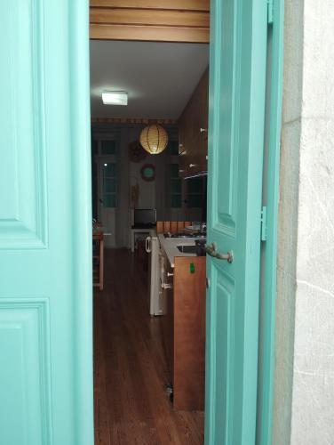 an open door to a kitchen with a table at 89 Steps Symi in Symi