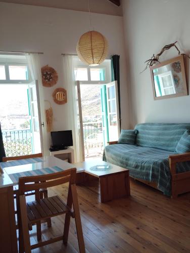 a living room with a bed and a table at 89 Steps Symi in Symi