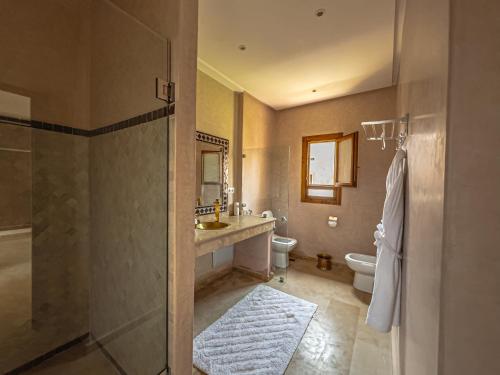 a bathroom with a shower and a sink and a toilet at Riad Kenza in Marrakech