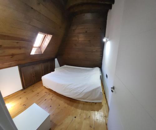 a small bedroom with a white bed in a room at Explora Pirineos Arán in Vielha
