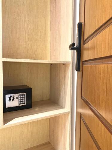 a door open to a cabinet with a clock on it at Villa Qeli in Gjirokastër