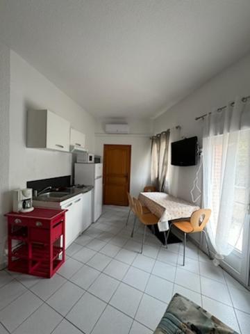 une cuisine avec une table et un astérisque d'astryastryastryasteryasteryasteryastery dans l'établissement appartement 4 personnes centre ville argeles sur mer petit prix, à Argelès-sur-Mer