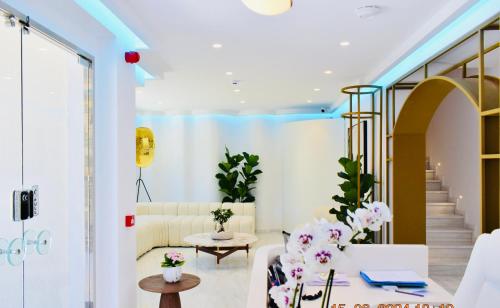 a living room with a couch and a table at Naiades Boutique Hotel - Adults Only in Elounda