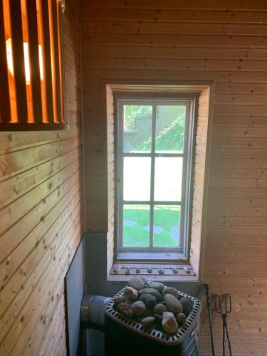 a window in the corner of a room with a large pot of rocks at Vingårdens Bed & Breakfast in Helsingborg