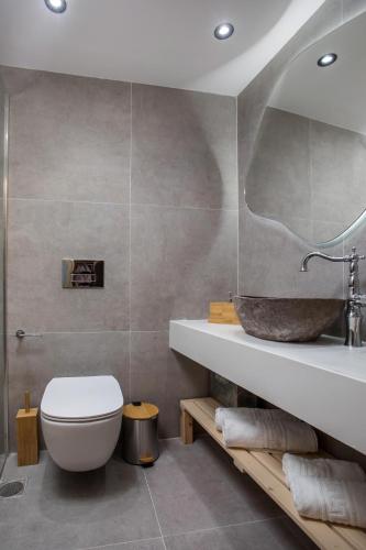 a bathroom with a white toilet and a sink at Alexandras Stone House in Rhodes Town