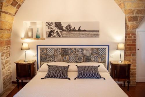 a bedroom with a large bed with two night stands at loft sul mare Sirolo in Sirolo