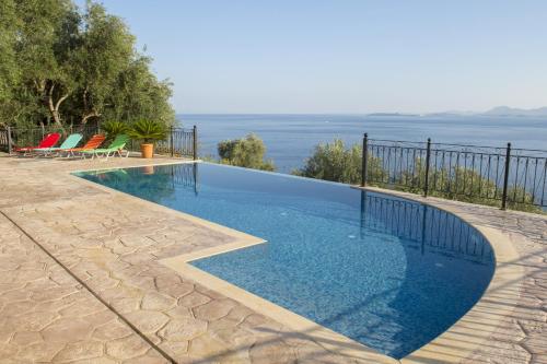 a swimming pool with a view of the water at Villa Daniella studio with private pool in Nisaki