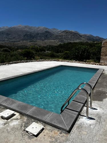 a swimming pool with a stairway leading into the water at Pulchra Campis,Private Pool,Wifi,Parking in Nerokoúros