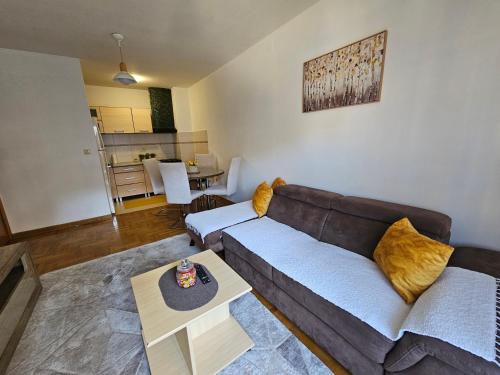 a living room with a couch and a table at Luča apartman in Podgorica