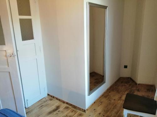 a white room with a mirror and a door at Plomari Nomad House in Plomarion