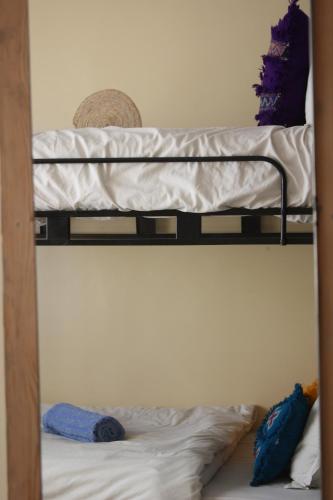 two bunk beds with pillows on the bottom bunk at Joy surf camp in Agadir