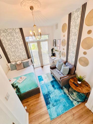 a living room with a couch and a table at Elegant Private Room opposite Queen Elizabeth Hospital - Harborne Birmingham R2 in Birmingham