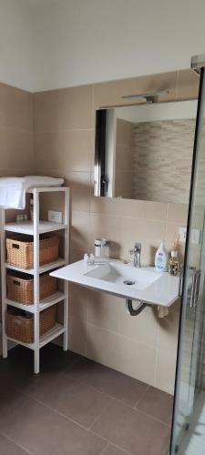 a bathroom with a sink and a mirror at Little Rose in Catania