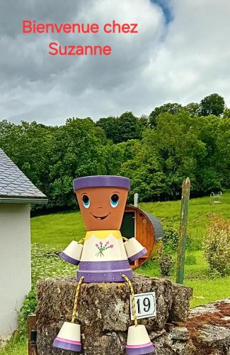 a toy figure sitting on top of a rock at Résidence de Suzanne Gîte avec sauna privatif in Brommat