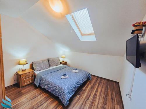 a bedroom with a bed and a skylight at Hvar apartmani & spa in Vrboska