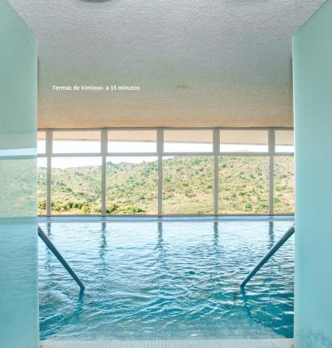 a swimming pool with a view of a mountain at Casa Sardinha in Valcerto
