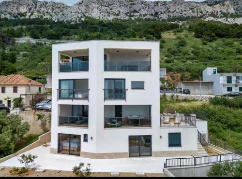 an aerial view of a white apartment building at Ivana&Luka-Put luke 1, Brela in Brela
