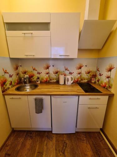 a kitchen with a sink and a counter top at Center Apartments Tukums in Tukums