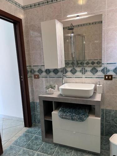 a bathroom with a sink and a mirror at La Noce Holiday House in Massa Lubrense