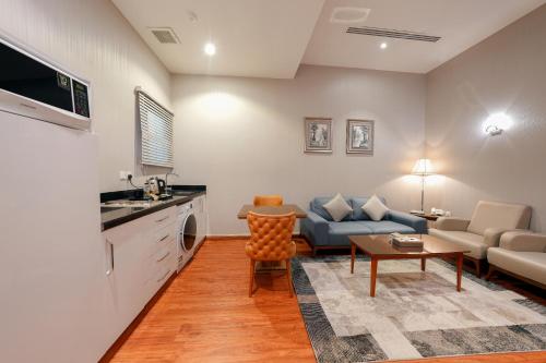 a living room with a couch and a table at Celine Home Serviced Apartment Al Malqa in Riyadh