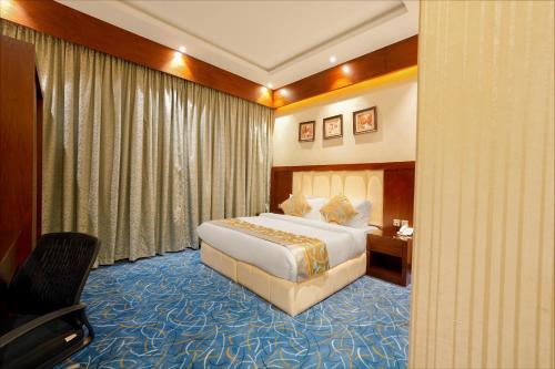 a hotel room with a bed and a desk at Celine Home Serviced Apartment Al Malqa in Riyadh