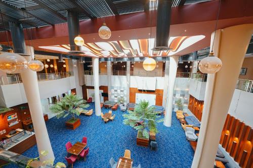 an overhead view of a lobby with couches and palm trees at Celine Home Serviced Apartment Al Malqa in Riyadh