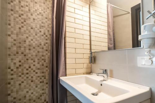 a bathroom with a sink and a mirror at Shato Luxe in Odesa