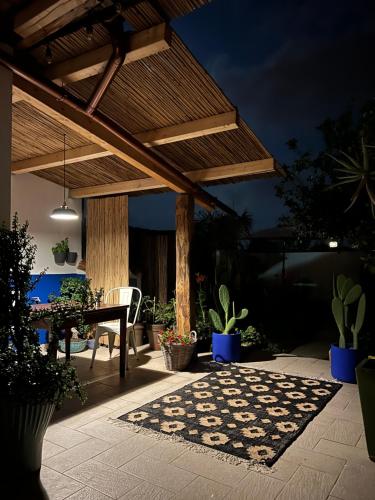 a patio with a wooden pergola and a table at Sustai in Càbras