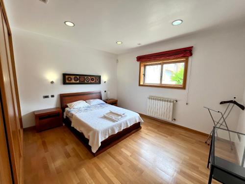a bedroom with a bed and a window at A Casa do Pai Carlos in Salreu