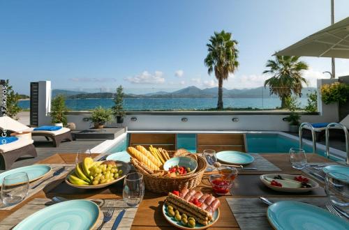 a table with a basket of fruit on a table at Dimitra's Paradise Villa in Lygia