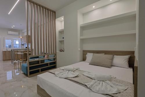 a bedroom with a large bed in a room at Gold Waves Luxury Studios by Pieria Riviera in Paralia Katerinis