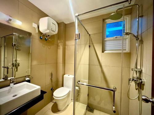 a bathroom with a toilet and a sink and a shower at Pearl Of Ocean Front in Trincomalee